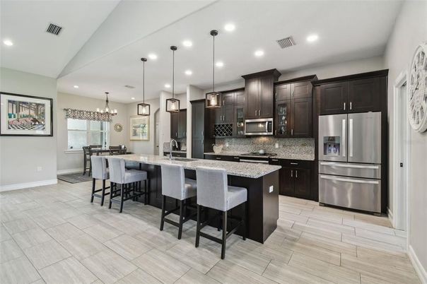 Chandelier, Dining room, Interior, Kitchen, Pendant Lights, Recessed Lighting, Stainless Steel Appliances, Wood Texture Flooring