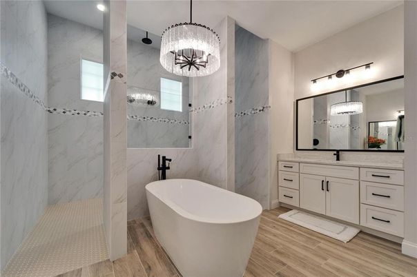 Bathroom, Dual Sink Vanities, Free Standing Baths, Interior, Marble Walls, Pendant Lights, Recessed Lighting, Wood Texture Flooring