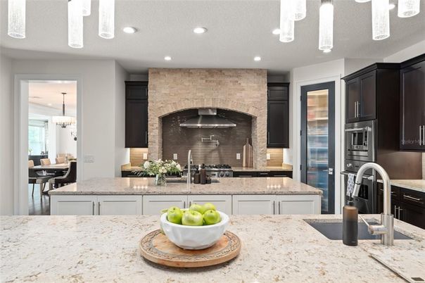 Chandelier, Dining room, Interior, Kitchen, Pendant Lights, Recessed Lighting, Stainless Steel Appliances, Stone Walls
