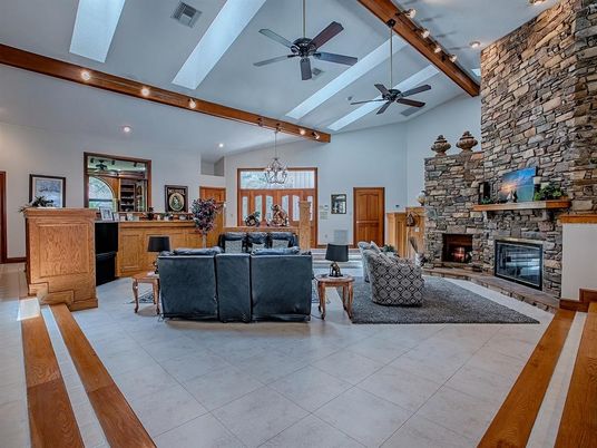 Chandelier, Fireplace, Interior, Living room, Recessed Lighting, Stone Walls, Wooden Beams
