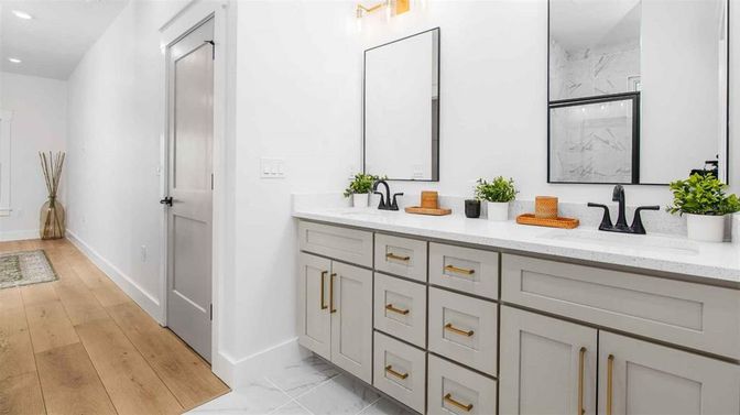Bathroom, Dual Sink Vanities, Interior, Marble, Marble Walls, Recessed Lighting, Wood Texture Flooring