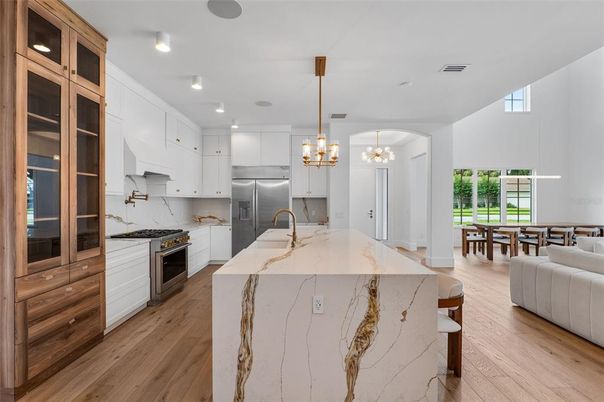 Chandelier, Interior, Kitchen, Pendant Lights, Recessed Lighting, Stainless Steel Appliances, Wood Texture Flooring
