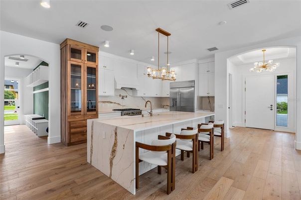 Chandelier, Interior, Kitchen, Marble Walls, Pendant Lights, Recessed Lighting, Stainless Steel Appliances, Wood Texture Flooring