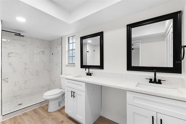 Bathroom, Dual Sink Vanities, Interior, Marble Walls, Recessed Lighting, Wood Texture Flooring