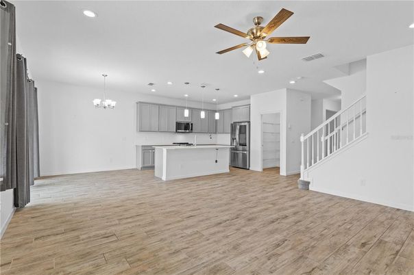 Chandelier, Empty room, Interior, Kitchen, Pendant Lights, Recessed Lighting, Stainless Steel Appliances, Wood Texture Flooring