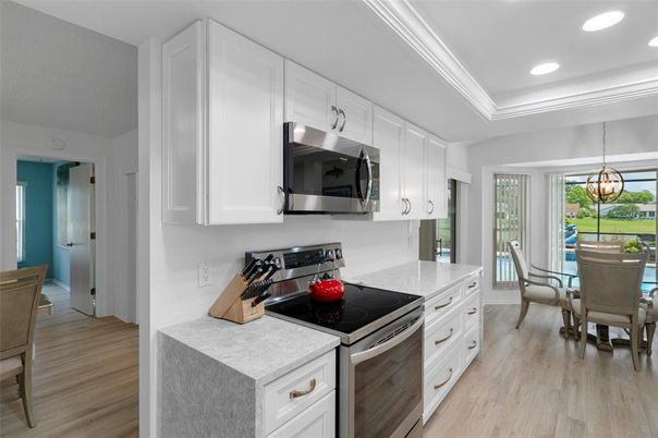Chandelier, Dining room, Interior, Kitchen, Pendant Lights, Recessed Lighting, Stainless Steel Appliances, Wood Texture Flooring