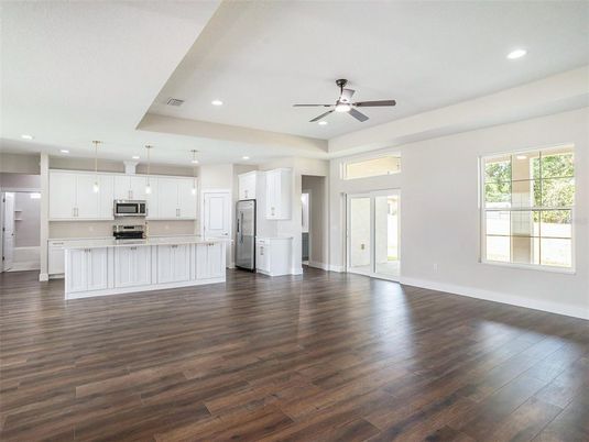 Empty room, Interior, Kitchen, Pendant Lights, Recessed Lighting, Stainless Steel Appliances, Wood Texture Flooring