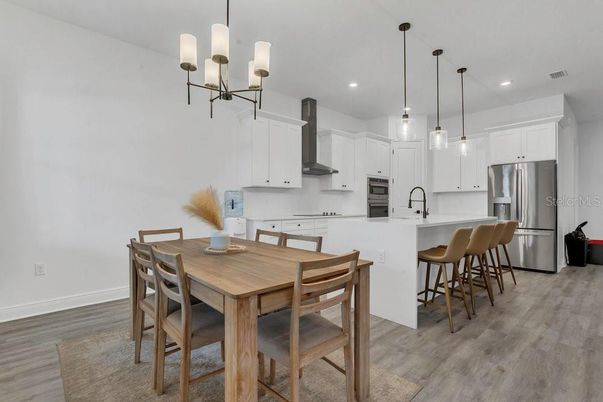 Dining room, Interior, Kitchen, Pendant Lights, Recessed Lighting, Stainless Steel Appliances, Wood Texture Flooring