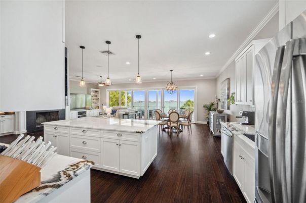 Chandelier, Dining room, Interior, Kitchen, Pendant Lights, Recessed Lighting, Stainless Steel Appliances, Water, Wood Texture Flooring