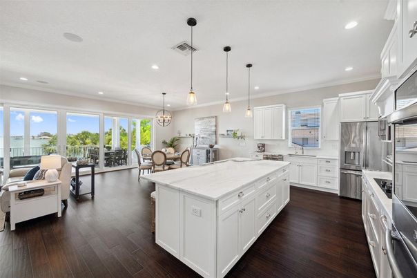 Chandelier, Dining room, Interior, Kitchen, Pendant Lights, Recessed Lighting, Stainless Steel Appliances, Wood Texture Flooring