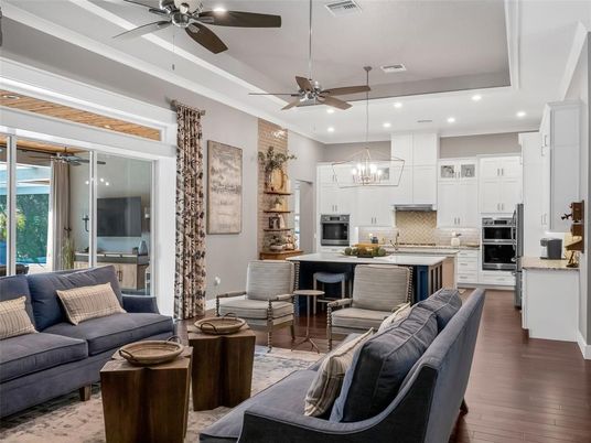 Chandelier, Dining room, Interior, Kitchen, Living room, Pendant Lights, Recessed Lighting, Stainless Steel Appliances, Wood Texture Flooring