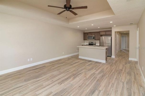 Empty room, Interior, Kitchen, Recessed Lighting, Stainless Steel Appliances, Wood Texture Flooring