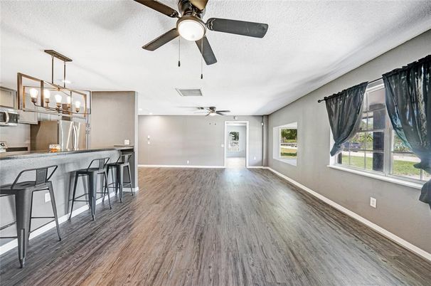 Empty room, Interior, Kitchen, Pendant Lights, Recessed Lighting, Stainless Steel Appliances, Wood Texture Flooring