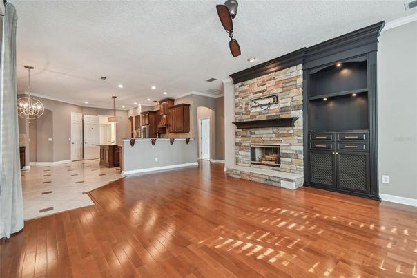 Empty room, Fireplace, Interior, Kitchen, Pendant Lights, Recessed Lighting, Stone Walls, Wood Texture Flooring