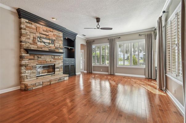 Empty room, Fireplace, Interior, Recessed Lighting, Stone Walls, Wood Texture Flooring