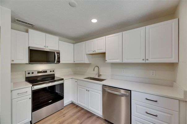 Interior, Kitchen, Recessed Lighting, Stainless Steel Appliances, Wood Texture Flooring