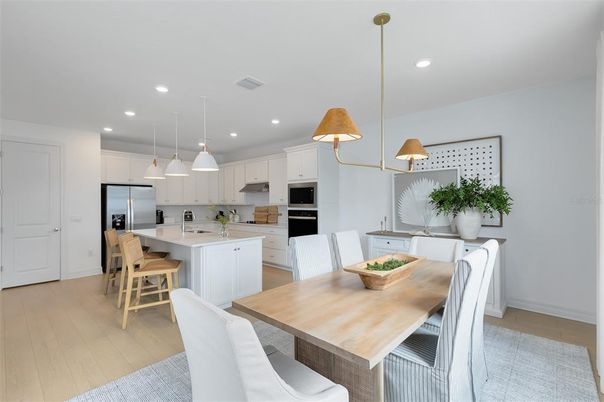 Dining room, Interior, Kitchen, Pendant Lights, Recessed Lighting, Stainless Steel Appliances, Wood Texture Flooring
