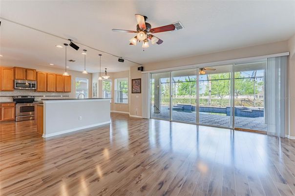 Empty room, Interior, Kitchen, Pendant Lights, Recessed Lighting, Stainless Steel Appliances, Wood Texture Flooring
