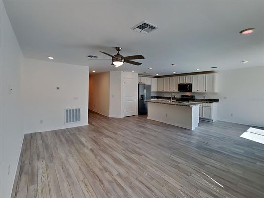 Empty room, Interior, Kitchen, Recessed Lighting, Stainless Steel Appliances, Wood Texture Flooring