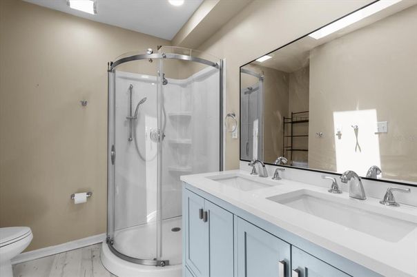 Bathroom, Dual Sink Vanities, Glass Shower, Interior, Recessed Lighting, Wood Texture Flooring