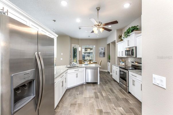 Dining room, Interior, Kitchen, Pendant Lights, Recessed Lighting, Stainless Steel Appliances, Wood Texture Flooring