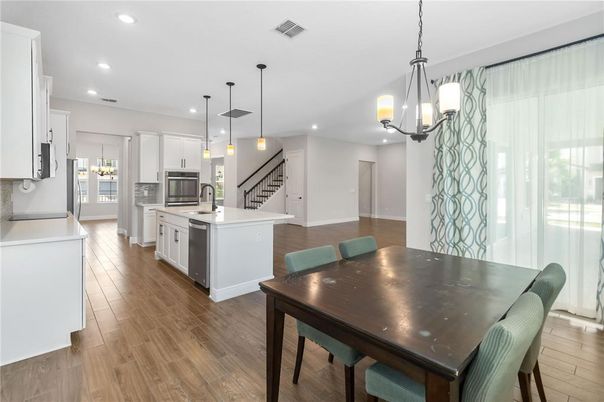 Dining room, Interior, Kitchen, Pendant Lights, Recessed Lighting, Stainless Steel Appliances, Wood Texture Flooring