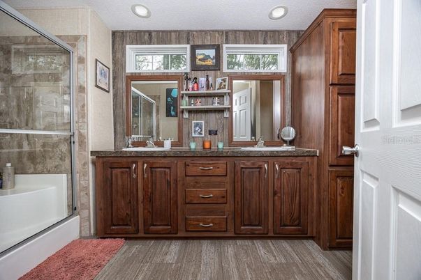 Bathroom, Dual Sink Vanities, Glass Shower, Interior, Recessed Lighting, Wood Texture Flooring