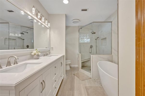 Bathroom, Dual Sink Vanities, Free Standing Baths, Glass Shower, Interior, Recessed Lighting, Wood Texture Flooring