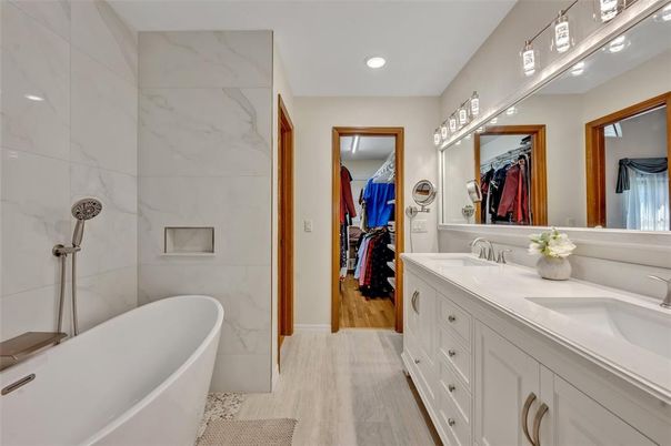 Bathroom, Dual Sink Vanities, Free Standing Baths, Interior, Marble Walls, Recessed Lighting, Walk-in Closets, Wood Texture Flooring