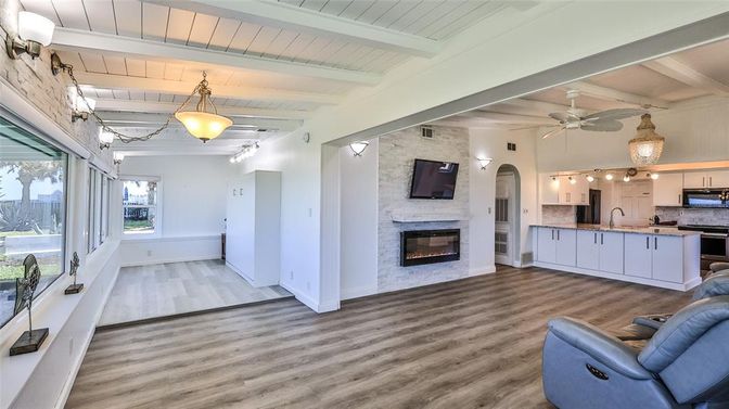 Fireplace, Interior, Kitchen, Living room, Pendant Lights, Stainless Steel Appliances, Stone Walls, Wood Texture Flooring
