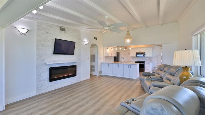 Fireplace, Interior, Kitchen, Living room, Pendant Lights, Stainless Steel Appliances, Stone Walls, Wood Texture Flooring