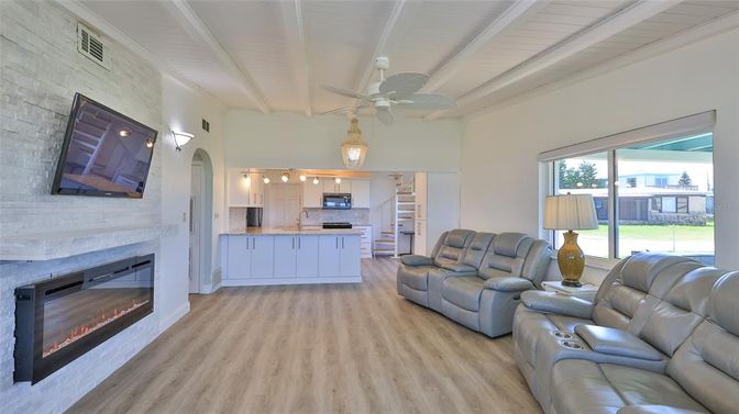 Fireplace, Interior, Kitchen, Living room, Pendant Lights, Stainless Steel Appliances, Stone Walls, Wood Texture Flooring