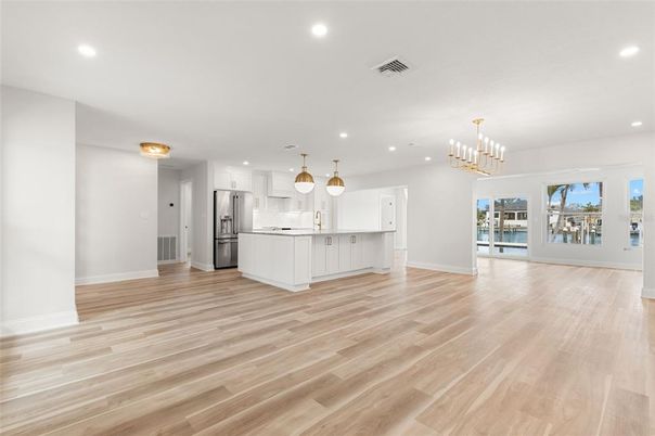 Chandelier, Empty room, Interior, Kitchen, Pendant Lights, Recessed Lighting, Stainless Steel Appliances, Wood Texture Flooring