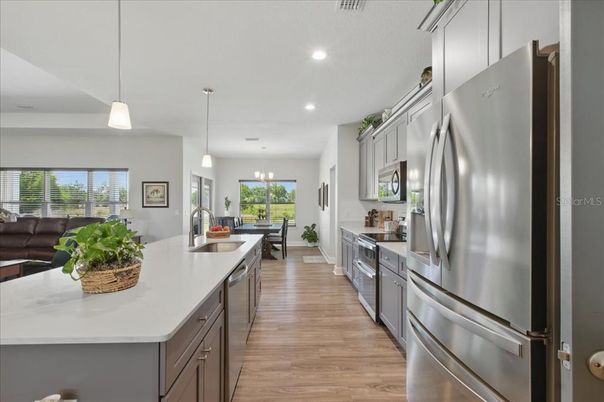 Dining room, Interior, Kitchen, Pendant Lights, Recessed Lighting, Stainless Steel Appliances, Wood Texture Flooring