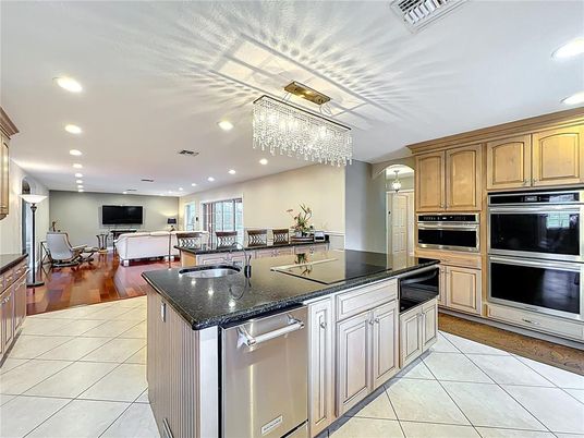 Chandelier, Fireplace, Interior, Kitchen, Living room, Recessed Lighting, Stainless Steel Appliances, Wood Texture Flooring