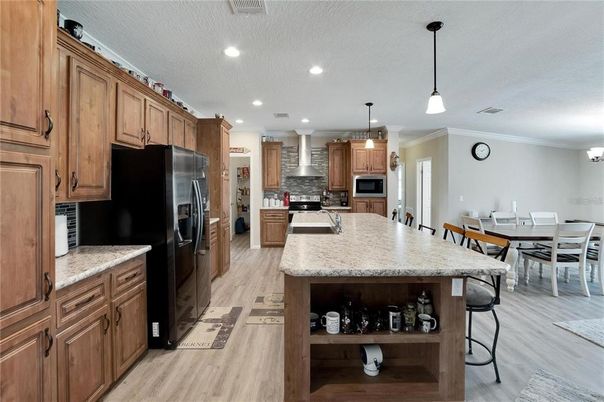 Dining room, Interior, Kitchen, Pendant Lights, Recessed Lighting, Stainless Steel Appliances, Wood Texture Flooring
