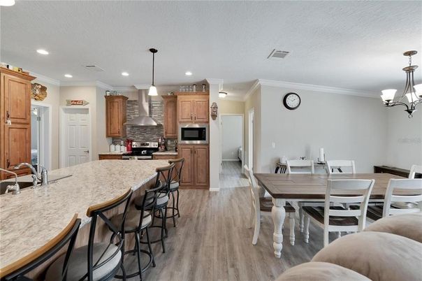 Chandelier, Dining room, Interior, Kitchen, Pendant Lights, Recessed Lighting, Stainless Steel Appliances, Wood Texture Flooring