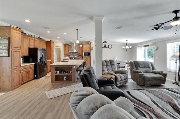 Chandelier, Dining room, Interior, Kitchen, Living room, Pendant Lights, Recessed Lighting, Stainless Steel Appliances, Wood Texture Flooring