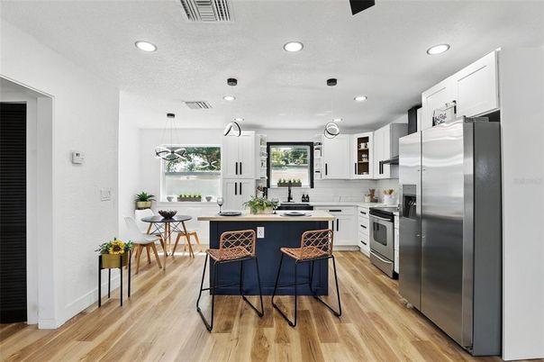 Dining room, Interior, Kitchen, Pendant Lights, Recessed Lighting, Stainless Steel Appliances, Wood Texture Flooring