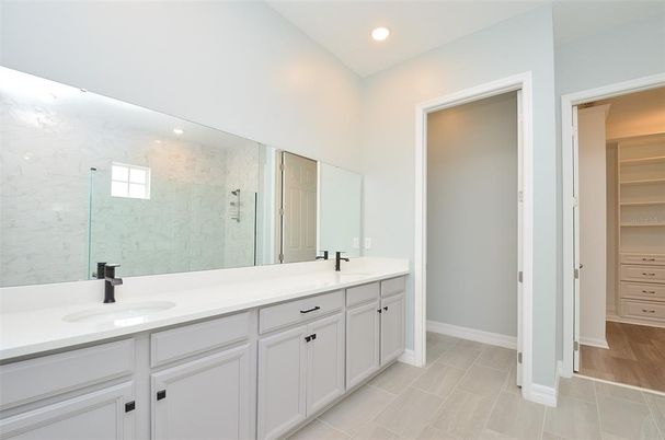 Bathroom, Dual Sink Vanities, Glass Shower, Interior, Marble Walls, Recessed Lighting, Walk-in Closets, Wood Texture Flooring