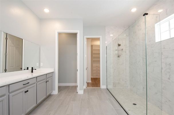 Bathroom, Dual Sink Vanities, Glass Shower, Interior, Marble Walls, Recessed Lighting, Wood Texture Flooring