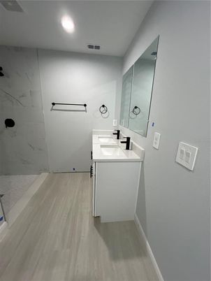 Bathroom, Dual Sink Vanities, Interior, Marble Walls, Recessed Lighting, Wood Texture Flooring