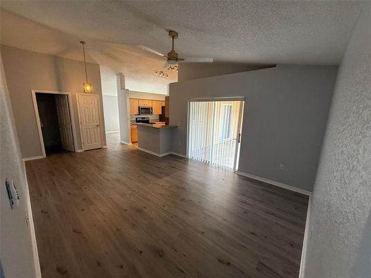 Empty room, Interior, Kitchen, Pendant Lights, Stainless Steel Appliances, Wood Texture Flooring