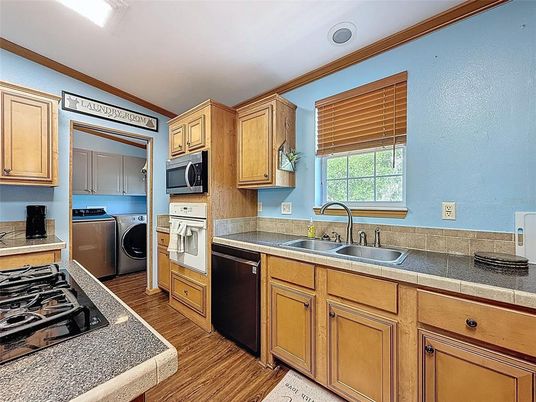 Interior, Kitchen, Tile Countertops, Washer, Wood Texture Flooring