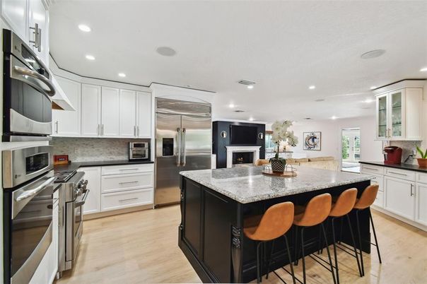Fireplace, Interior, Kitchen, Recessed Lighting, Stainless Steel Appliances, Wood Texture Flooring