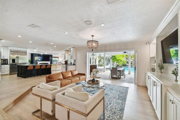 Chandelier, Dining room, Interior, Kitchen, Living room, Pendant Lights, Recessed Lighting, Stainless Steel Appliances, Wood Texture Flooring