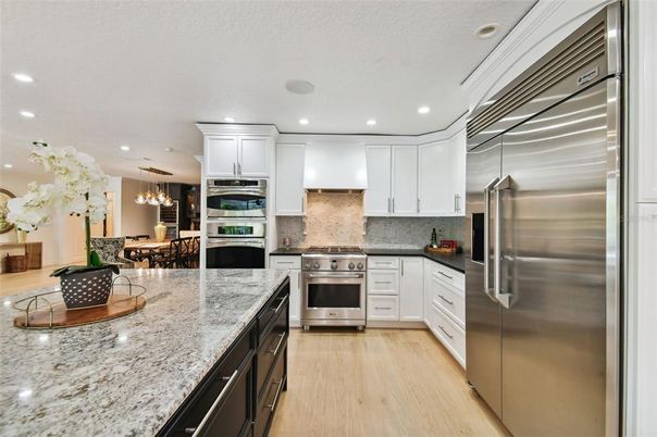 Chandelier, Dining room, Interior, Kitchen, Pendant Lights, Recessed Lighting, Stainless Steel Appliances, Wood Texture Flooring