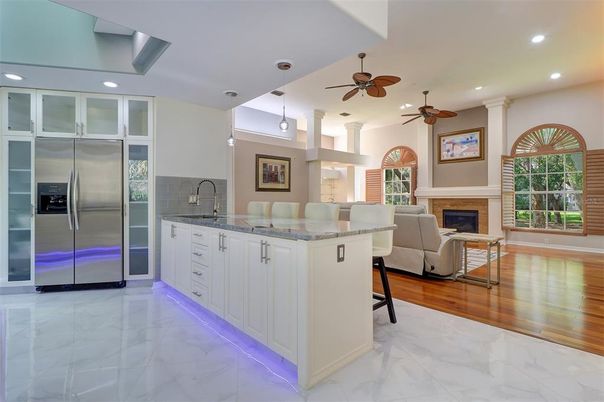 Fireplace, Interior, Kitchen, Living room, Marble, Pendant Lights, Recessed Lighting, Stainless Steel Appliances, Wood Texture Flooring