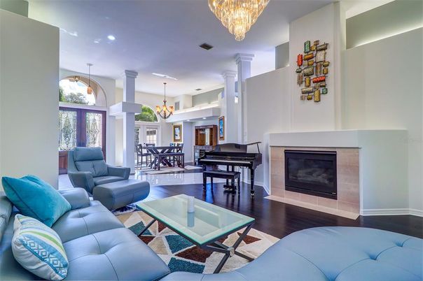 Chandelier, Dining room, Fireplace, Interior, Living room, Pendant Lights, Piano, Recessed Lighting, Wood Texture Flooring