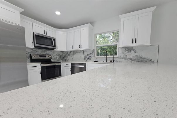 Interior, Kitchen, Marble Walls, Recessed Lighting, Stainless Steel Appliances